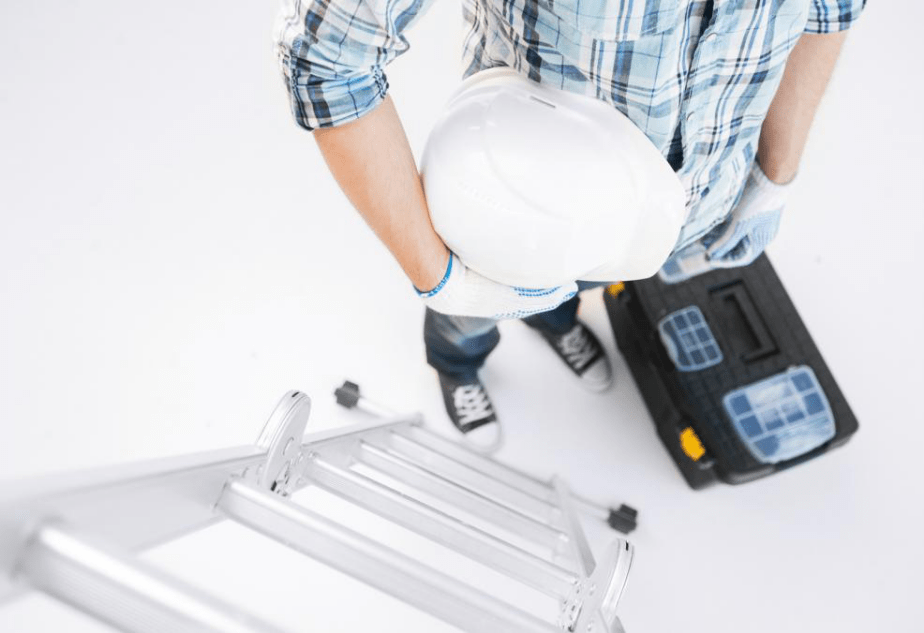 Man standing against the ladder